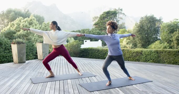 Lifestyle videos Outdoor of people doing activities, Practicing yoga, two women stretching on yoga m