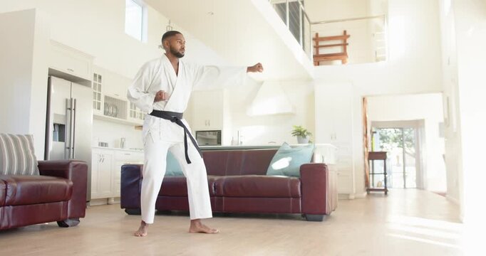 Lifestyle videos indoor of people doing activities at home, practicing martial arts, man in karate u