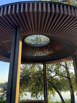 Bottom up shot of contemporary gazebo roof with circular geometric design.