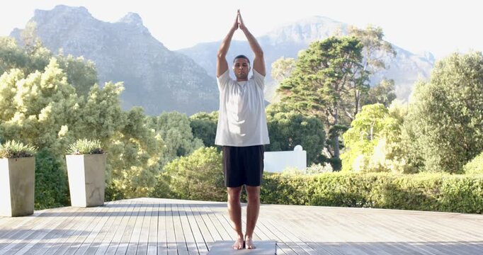 Lifestyle videos outdoor of people doing activities, practicing yoga, man standing on yoga mat outdo