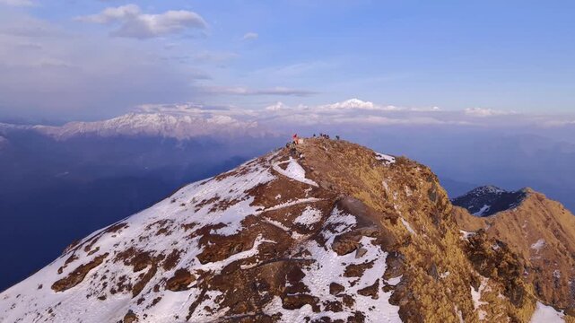 Aerial drone footage of snow-covered Chandrashila Peak near Chopta, Uttarakhand, India, captured during winter.
