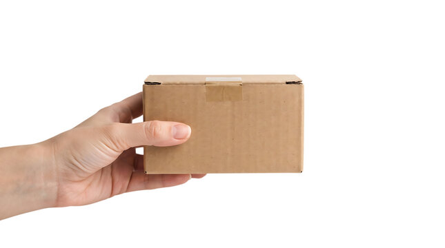 A hand holding a small brown cardboard shipping box isolated on transparent background