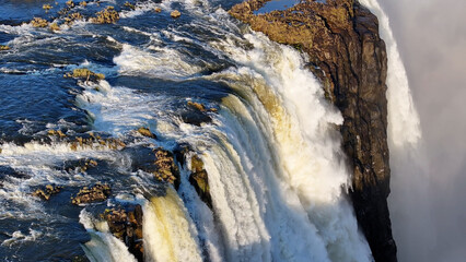 Obraz premium Victoria Falls At Livingstone In Northern Rhodesia Zambia. Giant Waterfalls. Nature Landscape. Livingstone At Northern Rhodesia Zambia. Zambezi River. Travel Scenery.