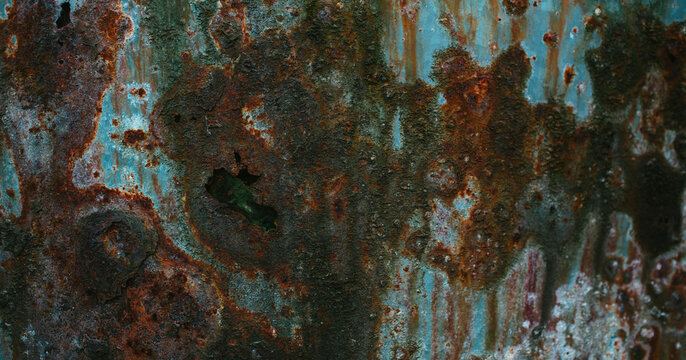 Weathered rusted metal surface texture with peeling teal paint corrosion and distressed vintage grunge wall details
