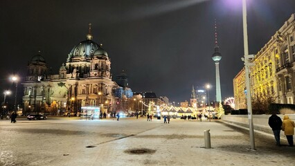 Berlin Cathedral and TV Tower illuminated at night in winter, showcasing Berlin's iconic skyline, festive city lights, and historic architecture © Riky