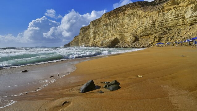 Red Beach, dream beach in the neighboring bay of Matala, empty sandy beach in front of majestic cliffs and turquoise sea under blue sky, Matala, south coast, Crete, Greek Islands, Greece