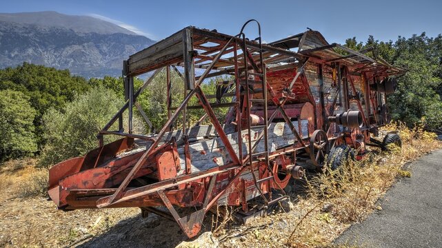 Psiloritis, Ida Massif, highest mountain in Crete, rusty machinery parts on a road in front of a lush forest landscape and mountains, Amari Basin, Central Crete, Greek Islands, Greece