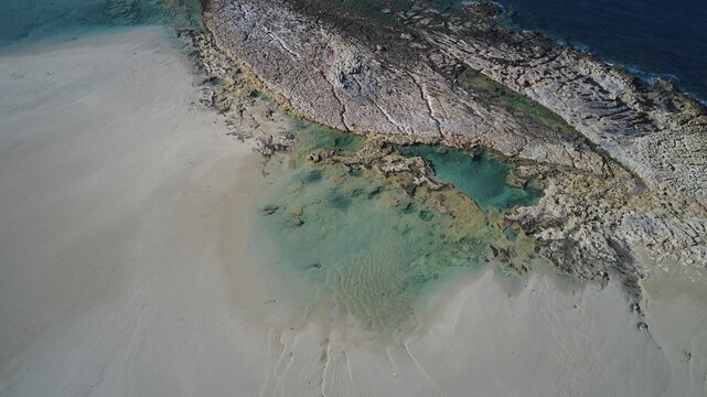 Drone shot, coastline with light-coloured sand and crystal clear turquoise water, interspersed with rocks, Gramvoussa, Gramvoussa peninsula, Pirate Bay, Balos, lagoon, northwest Crete, Crete, Greek Islands, Greece