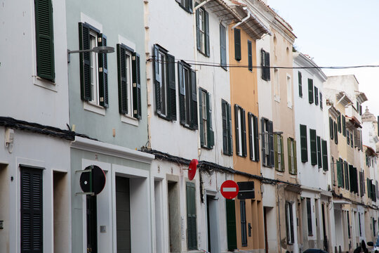 Mahon street with colorful buildings and closed shutters