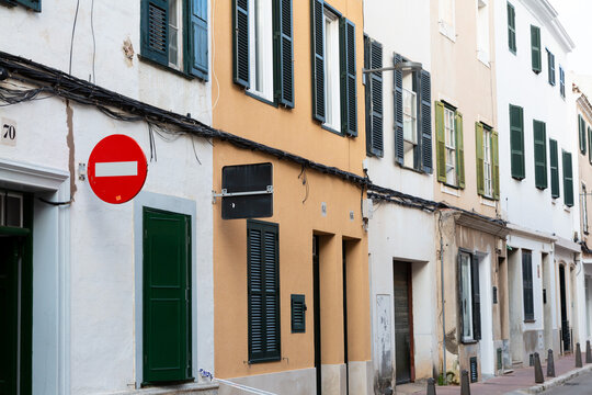 Mahon street with colorful buildings and closed shutters