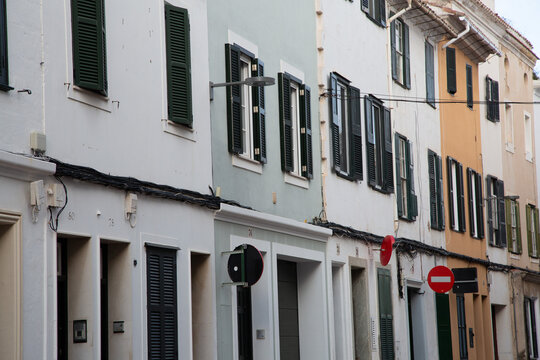 Mahon street with colorful buildings and closed shutters