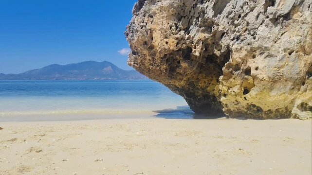 Calming sea waves. Surface and texture of pristine blue turquoise sea water during a hot summer day. Sand, beach, shore, costline