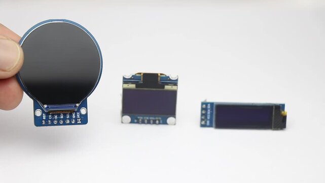 Round display module and rectangular oled modules of different sizes on white background