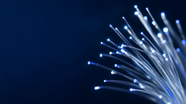 Blue illuminated optical fibers against a dark technology background