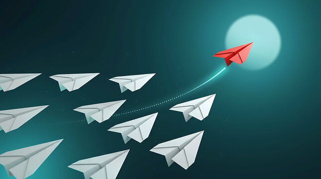 Red paper airplane breaking away from white fleet representing leadership concept