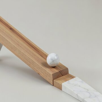 Wood and marble balance toy on a light background with a round ball