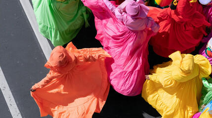 Obraz premium Vibrant Dancers Wearing Colorful Traditional Dresses Participate In The Lively Annual Carnaval de San Miguel Street Parade Celebrating Local Culture
