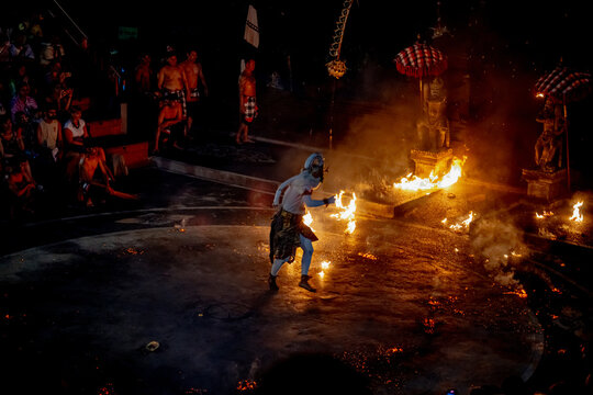BALI, INDONESIA &ndash; OCTOBER 19, 2024: White monkey god Hanuman dancing through blazing fire during sacred Kecak show at Uluwatu.