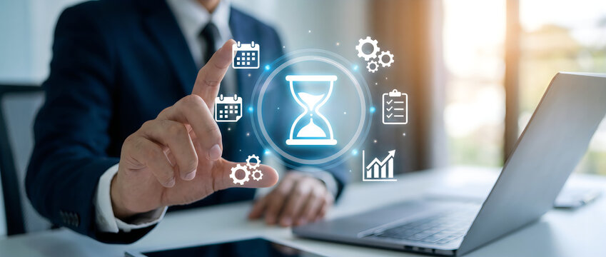Business professional gesturing over digital productivity icons on laptop screen