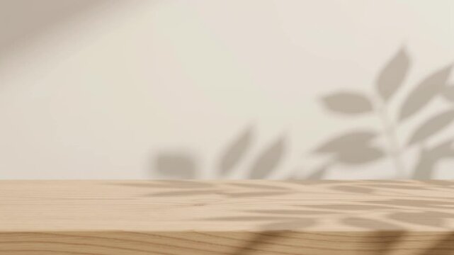 Minimalist wooden podium with leaf shadows on beige background creating serene cinematic presentation space.