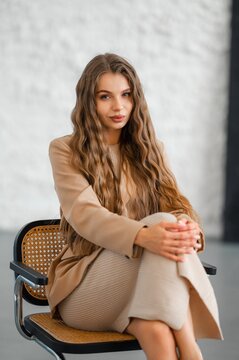 Young woman portrait in neutral studio lighting, long wavy hair and natural makeup with confident expression, with woman, portrait, female, young detail, showing adult, long, wavy, hair context