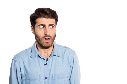 Close up photo of amazing multiethnic guy looking side empty space not believe eyes scary situation wear casual denim shirt isolated white color background