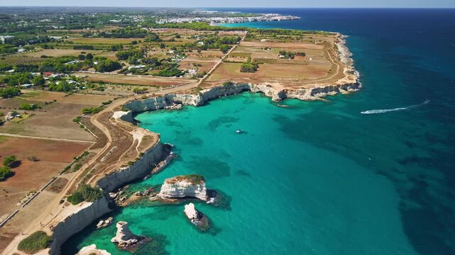 Aerial view of Faraglioni di Sant'Andrea sea stacks in Puglia, Puglia, Italy