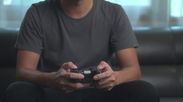 Gaming, controller and man on sofa for relax, streaming and esports subscription. Challenge, competition and virtual with person in living room at home for contest, tournament or video games. joystick
