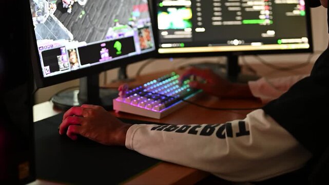 gamer using gaming pc professional setup while having fun playing online video games at home. Man enjoy relax free time play multiplayer competition. Keyboard and mouse desk Desktop. laptop computer