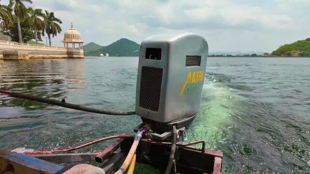 Outboard motor propelling a boat on Lake Pichola in Udaipur Rajasthan India