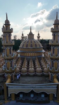 Architectural aerial view of 201 dome mosque in tangail bangladesh at sunset with dramatic cloudscape.