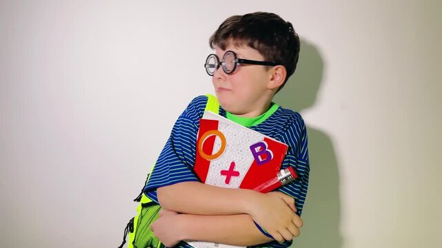 A young schoolboy looks around with an anxious and fearful expression, tightly clutching his notebook and school supplies. Wearing a bright green backpack and striped shirt, he appears nervous and int
