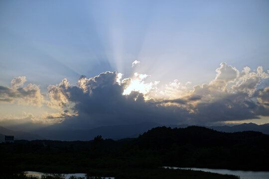 sunbeams through evening clouds