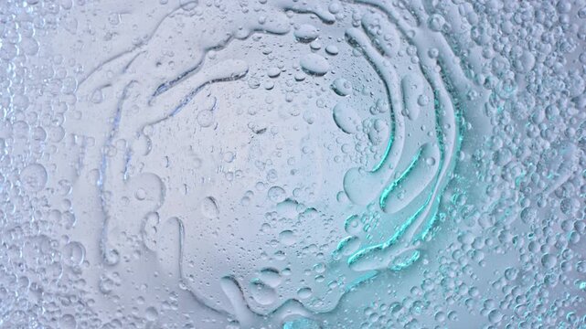 Super Slow Motion Shot of Rotating Oil in Water at 1000fps. Abstract Cosmetic Background.
