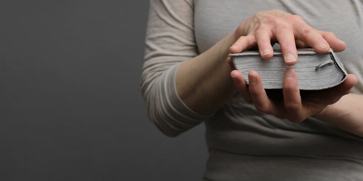 praying to god with hands on bible religious showing faith with God woman praying with background with people stock photo stock image