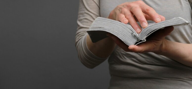 praying to god with hands on bible religious showing faith with God woman praying with background with people stock photo stock image