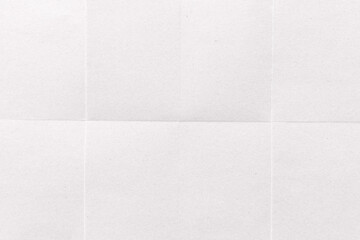 Obraz premium A textured white paper background with subtle grid lines and folds.