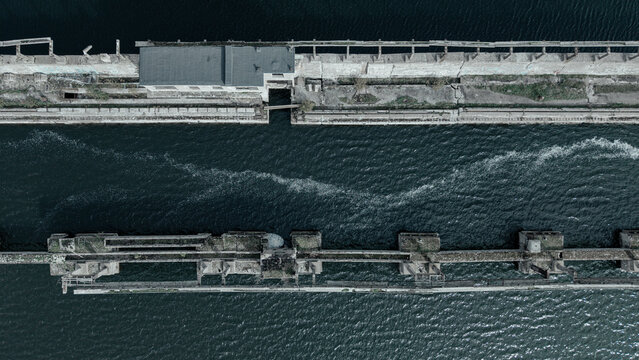 Aerial top down view of abandoned Soviet submarine base pier in Baltic sea