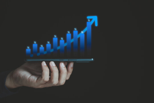 Close-up of a businessman's hand holding a smartphone with a percentage financial growth graph for a company. Financial goals and global economic business planning.