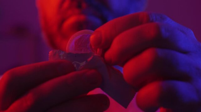 Protection, safe love and contraceptive concept. Bearded man take out latex condom from package