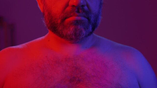 Protection, safe love and contraceptive concept. Bearded man showing latex condom package into camera