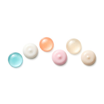 Colorful skincare cream and serum drops in soft pastel shades on clean white background
