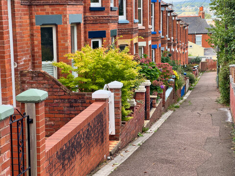 Traditional British Red Brick Terraced Houses and Narrow Alleyway with Front Gardens