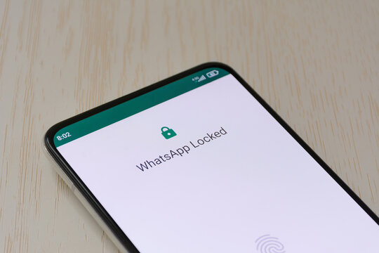 Messaging app locked screen with fingerprint security on smartphone