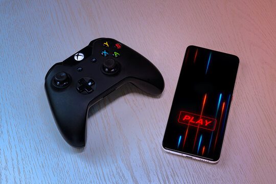 Mobile gaming setup with smartphone and wireless game controller on desk