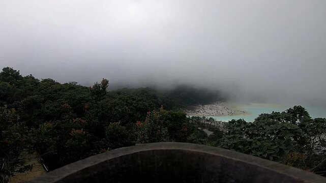 Scenic foggy view of Kawah Putih volcanic crater lake in West Java