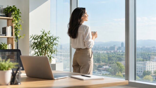 Contemplative Moment: A Professional Woman Enjoying Her Coffee While Gazing Out Over a Scenic Cityscape from a Modern Office