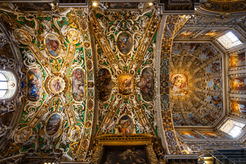 Richly decorated ceiling with paintings, gilding and stucco work of the Basilica di Santa Maria Maggiore in the upper town of Bergamo © Ldgfr Photos