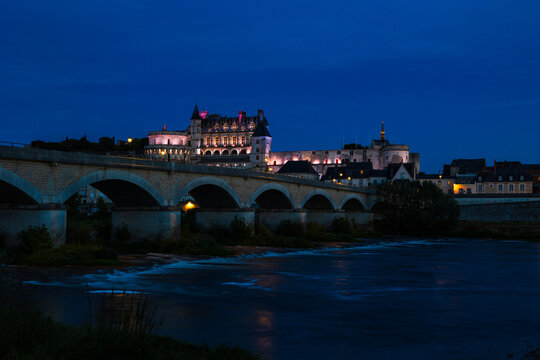 Amboise Royal Castle at dusk in the background of the Pont du Mar&eacute;chal Leclerc, seen from the banks of the Loire river