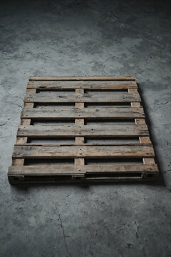Old Weathered Wooden Pallet Lying On Cracked Gray Concrete Floor With Empty Copy Space